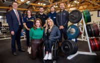 A group of people posing together inside the South Australian Sports Institute gym.