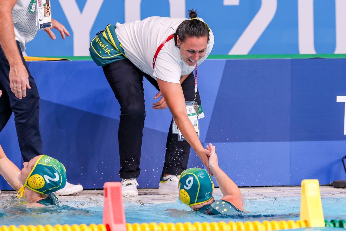Bec Rippon shaking the hand of Stingers player  during the Tokyo 2020 Olympic Waterpolo Tournament