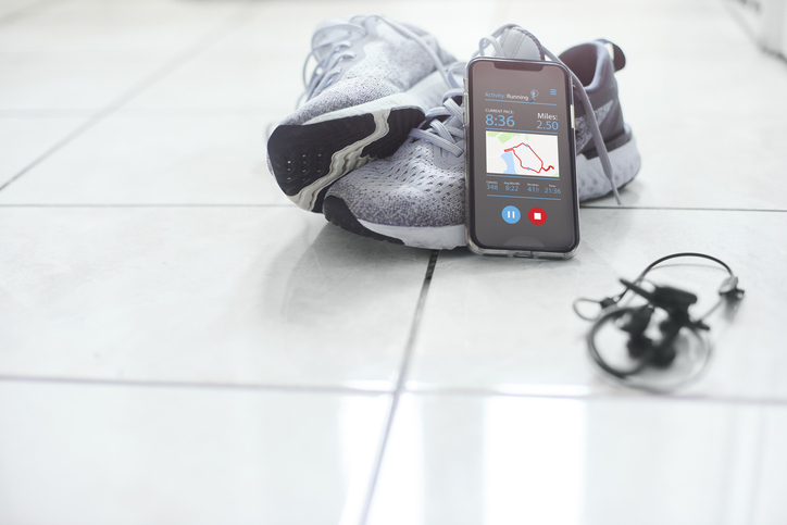 running shoes and phone with map