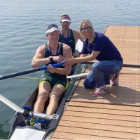 Athletes sitting in their boat on the water 