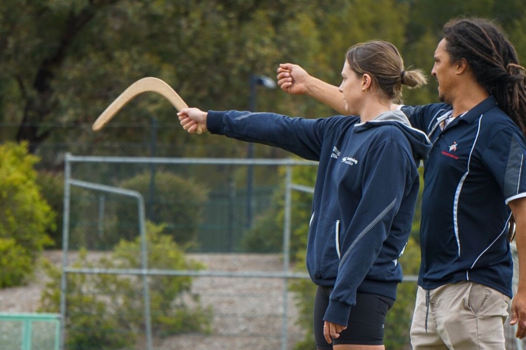 Bianca standing holding boomerang.