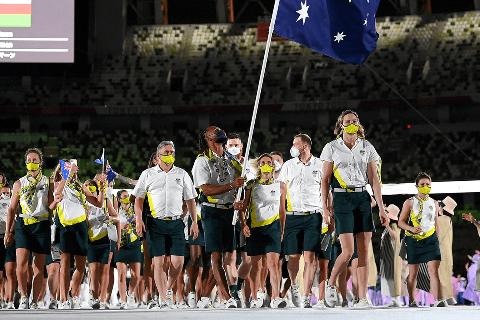 Flag bearer Patrick Mills leads the Australian Olympic Team into Tokyo Stadium for the games' opening ceremony.