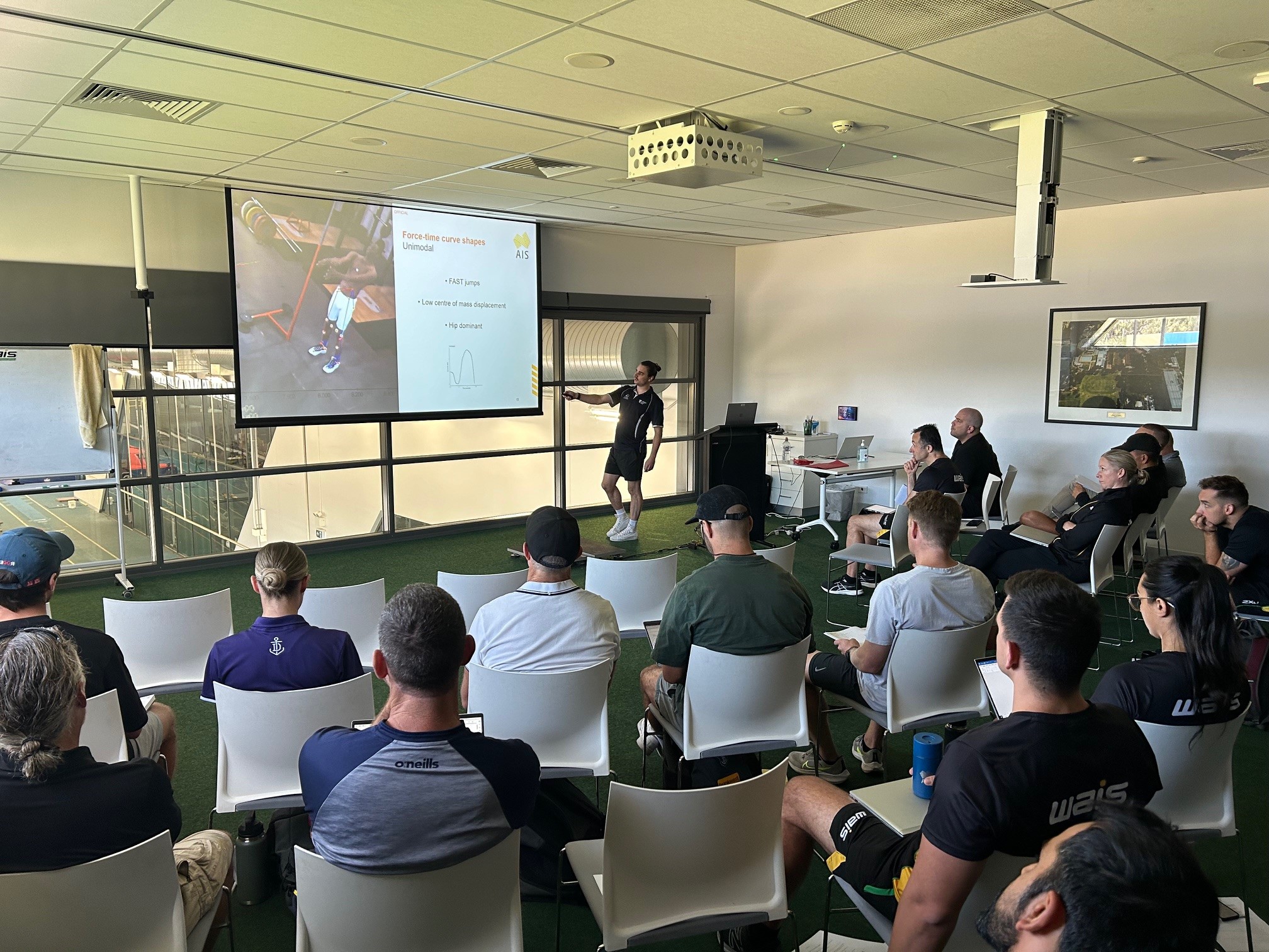 People in room watching presentation