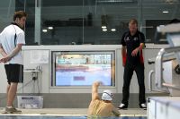 Coach John Fowlie uses the poolside monitors to help coach his athletes 2009