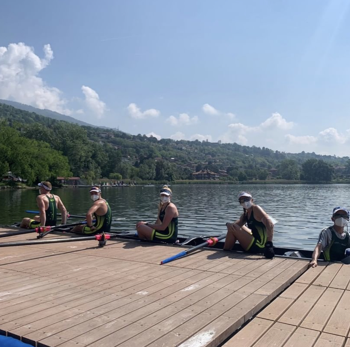 Athletes sitting in their boat on the water 