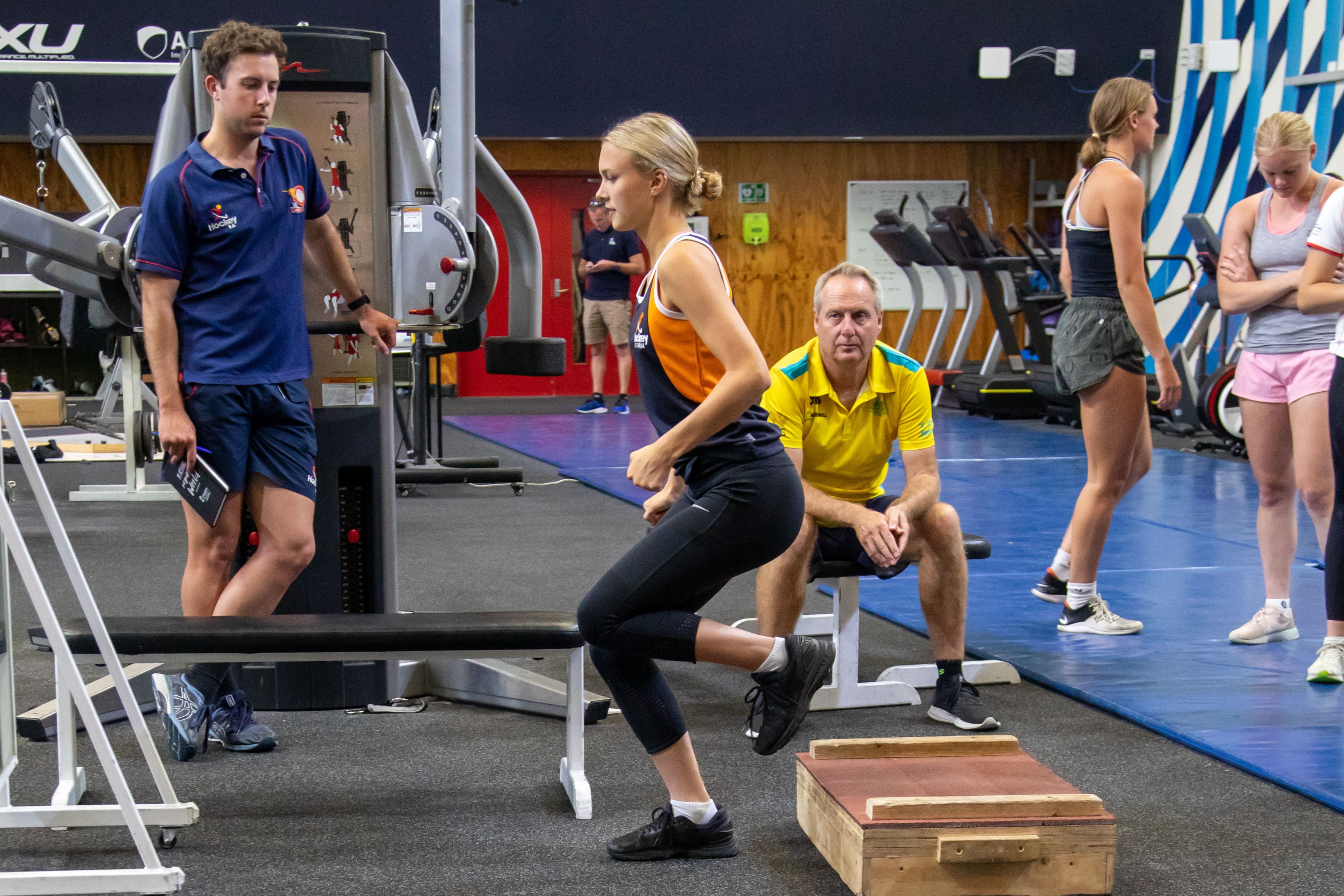 Athlete performs single leg test in gym.