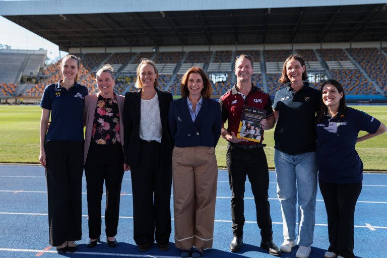 A group of athletes and researchers gather around Sports Minister Anika Wells at the launch of the AIS Parenthood Recommendations