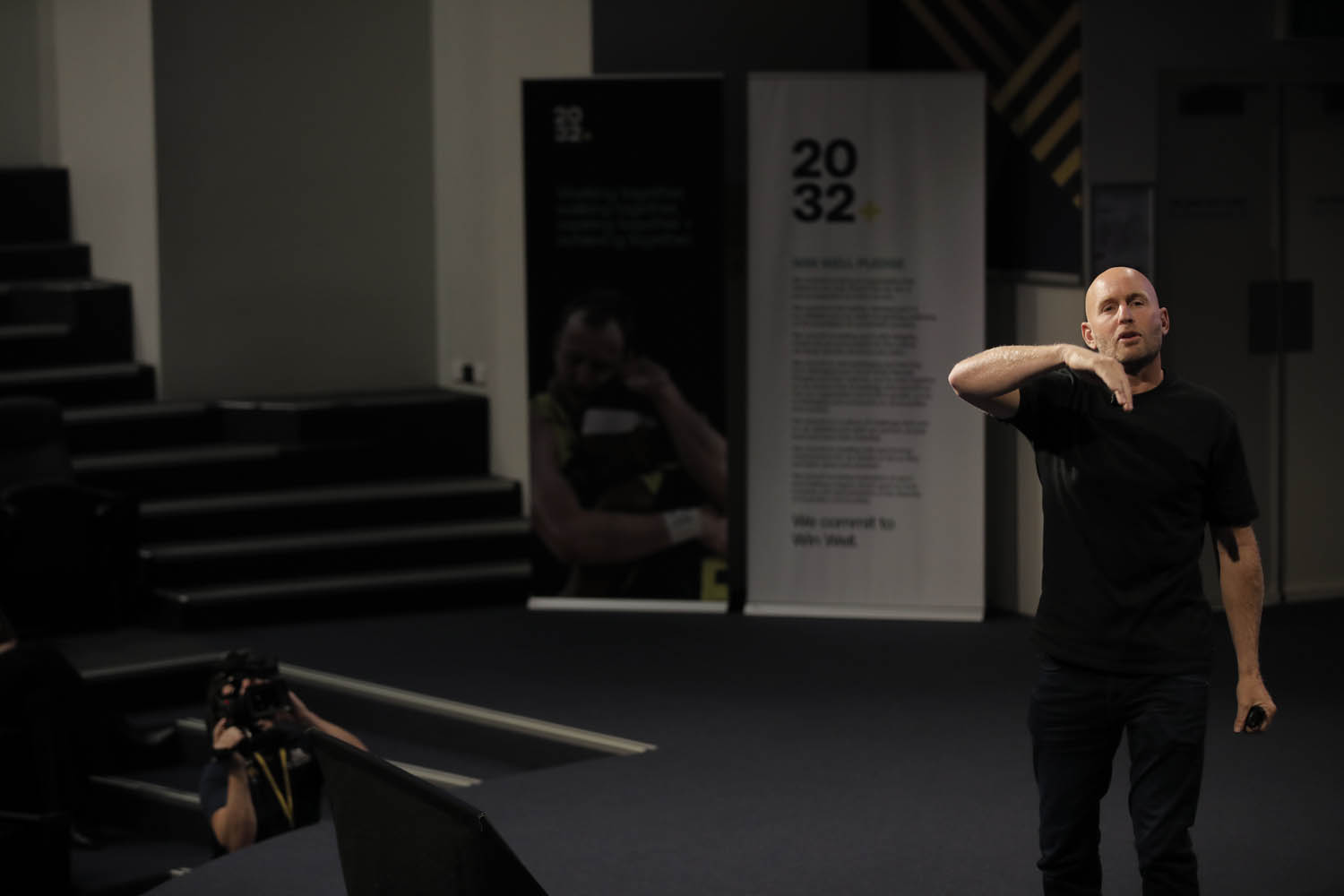 A man gestures while on stage