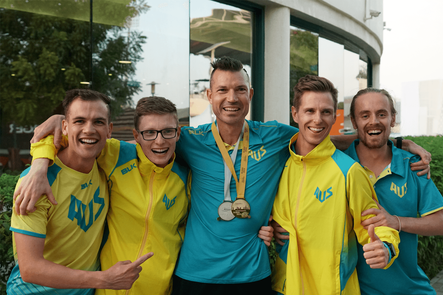 Coach Philo Saunders, centre, with athletes Deon Kenzie, Jaryd Clifford, left, and Michael Roeger and 