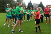 Rugby 7s players interact with children on the field