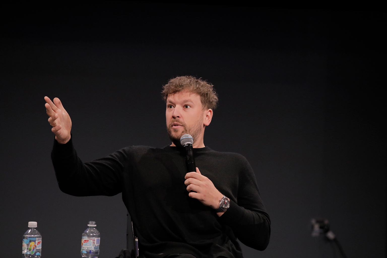 Dylan Alcott speaking into a microphone