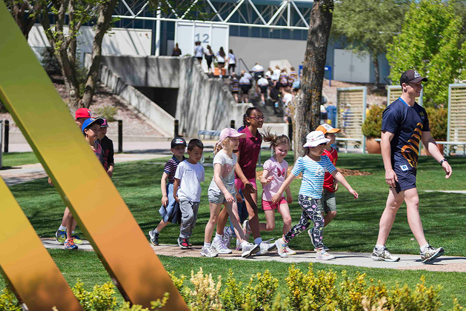 Children follow tour guide outside at AIS.